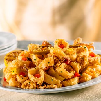 The Capital Grille - Pan-Fried Calamari with Hot Cherry Peppers – Our signature appetizer - crisp and golden with a fiery flavor. - Steakhouses Near Me - Troy, Michigan The Capital Grille - Pan-Fried Calamari with Hot Cherry Peppers – Our signature appetizer - crisp and golden with a fiery flavor. - Steakhouses Near Me - Troy, Michigan
