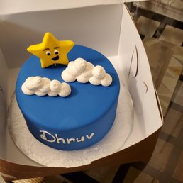 a blue cake with a yellow star on top