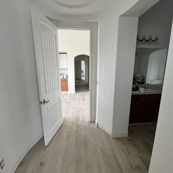 Tinos Luxury Flooring - a hallway leading to a bathroom - Flooring Near Me Tinos Luxury Flooring - a hallway leading to a bathroom - Flooring Near Me