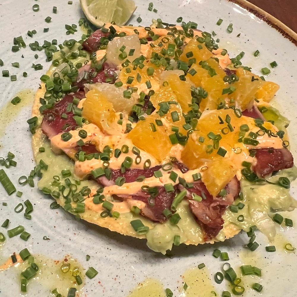 Pajarito - The tuna tostada with seared Ahi over an avocado crema, topped with all the citrus flavors. - Mexican Near Me - Edina, Minnesota