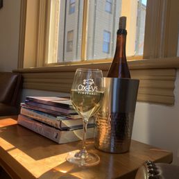 a glass of wine on a table a glass of wine on a table
