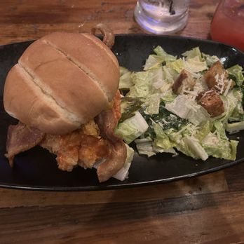 Mash'D - The Bird chicken sandwich with added bacon and cheese and a Caesar salad - New American Near Me - San Antonio, Texas