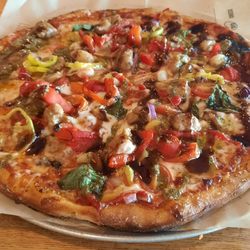 I generally go with sausage, onion, roasted garlic, roasted red pepper, banana pepper, tomatoes, basil and probably a couple other toppings.