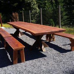 M4 Specialties - 15' L x 34-36" W Live Edge Curly Redwood Table with 6-5' benches .Table has 2 George Jetson bases and a trestle