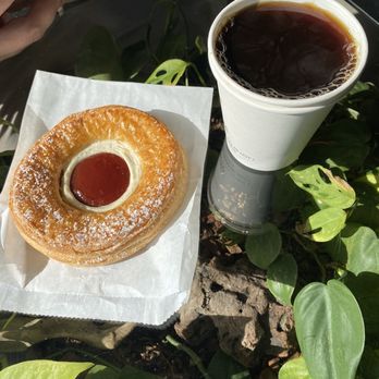 Triune Coffee - Guava pastry and drip coffee over a table with plant decor - Coffee & Tea Near Me - Huntington Beach, California Triune Coffee - Guava pastry and drip coffee over a table with plant decor - Coffee & Tea Near Me - Huntington Beach, California