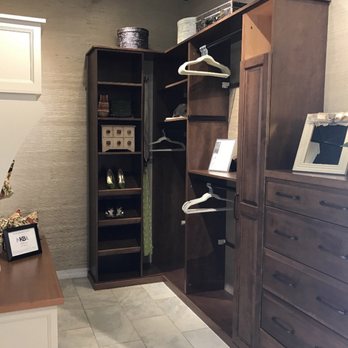 Fairmont Kitchen Center - Stained birch closet system display, along with painted mud room display on left. - General Contractors Near Me - Fairmont, West Virginia Fairmont Kitchen Center - Stained birch closet system display, along with painted mud room display on left. - General Contractors Near Me - Fairmont, West Virginia
