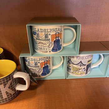 Starbucks - a stack of starbucks mugs on a shelf - Coffee & Tea Near Me - Ruby, New York