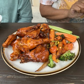 Village Corner Comfort Kitchen & Bar - Hot Hot Wings with sautéed veggies (wings are more sweet than hot) - Southern Near Me - CONCORD, North Carolina Village Corner Comfort Kitchen & Bar - Hot Hot Wings with sautéed veggies (wings are more sweet than hot) - Southern Near Me - CONCORD, North Carolina