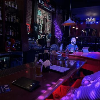 The Red Piano - a man sitting at a bar - Cocktail Bars Near Me - Santa Barbara, California The Red Piano - a man sitting at a bar - Cocktail Bars Near Me - Santa Barbara, California
