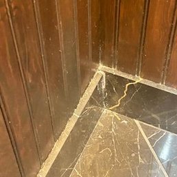 Filth on top of baseboard in the bathroom