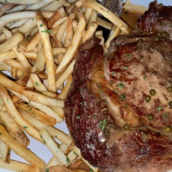 Entre Nous French Bistro - Entrecôte au Poivre ($52), a 10 oz ribeye steak with peppercorn sauce, and French fries. - Wine Bars Near Me - Pasadena, California Entre Nous French Bistro - Entrecôte au Poivre ($52), a 10 oz ribeye steak with peppercorn sauce, and French fries. - Wine Bars Near Me - Pasadena, California