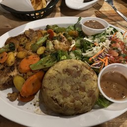 Tilapia mofongo with veggies and house salad.
