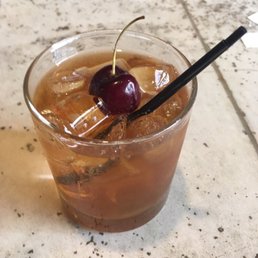 a drink with a cherry on top a drink with a cherry on top