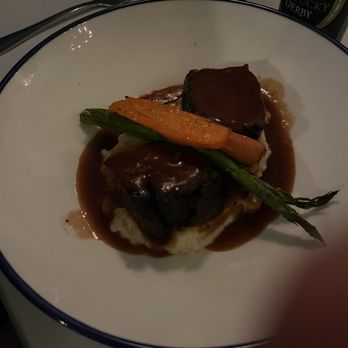 Otto's - Filet - A dinner plate features beef with gravy, mashed potatoes, and roasted vegetables, including carrots and green beans, served in a restaurant setting. - Breakfast & Brunch Near Me - Covington, Kentucky