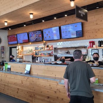 Fromagerie Victoria - a man standing at a counter in a restaurant - Poutineries Near Me - Saint-Jérôme, Quebec Fromagerie Victoria - a man standing at a counter in a restaurant - Poutineries Near Me - Saint-Jérôme, Quebec