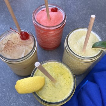 Sunshine Grill - Clockwise from top: Frozé, Peach Basil Summer Smash, Mango Massage, the Painkiller - New American Near Me - Grand Cayman, Virgin Islands Sunshine Grill - Clockwise from top: Frozé, Peach Basil Summer Smash, Mango Massage, the Painkiller - New American Near Me - Grand Cayman, Virgin Islands