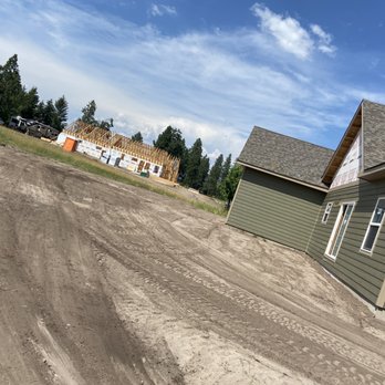 Country Boy Tractor - a dirt road in front of a house - General Contractors Near Me
