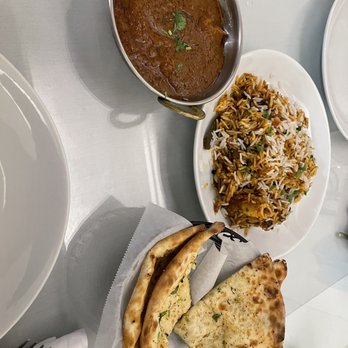 Delicious Curry House - a variety of dishes on a table - Indian Near Me - Oakland, California
