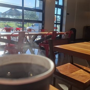 Black Rock Coffee Bar - Morning sun flooding in over the steam of a hot Americano. - Coffee & Tea Near Me - Houston, Texas Black Rock Coffee Bar - Morning sun flooding in over the steam of a hot Americano. - Coffee & Tea Near Me - Houston, Texas