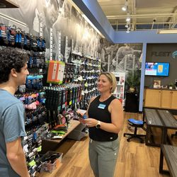 Fleet Feet - Wendy M. discusses sock options with a guest.
