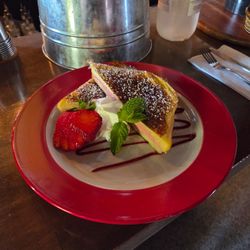 Raspberry Cream Cheese Stuffed French Toast with whipped cream and strawberry - Sun Brunch menu