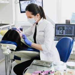 River's Edge Dental - Dentist providing dental cleaning to patient