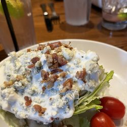99 Restaurants - Lettuce wedge with bacon tips blue cheese dressing and tomatoes