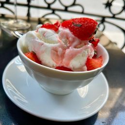 a bowl of ice cream and strawberries
