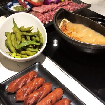 Halves Boiling Pot + Grill - Our sample plate, half tonkotsu broth and half grill, with Japanese sausage and Edamame - Japanese Near Me - Foothill Ranch, California