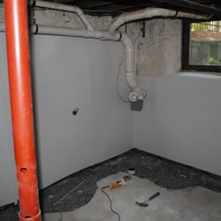 All County Waterproofing - Glass board on stone foundation