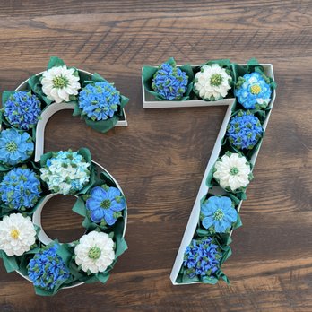 Tiny Yummy Cakes - Closeup view of the number bouquet for a 67th birthday. Chocolate cupcakes with almond frosting shaped into multiple flowers. - Cupcakes Near Me