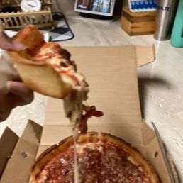 Doughy undercooked pizza . Doughy undercooked pizza .