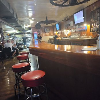 Longbranch Steakhouse - a bar with red stools - Steakhouses Near Me - Gifford, Illinois Longbranch Steakhouse - a bar with red stools - Steakhouses Near Me - Gifford, Illinois