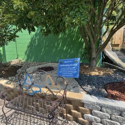 Eggleston Garden Center - Quaint bench and information of landscaping services Eggleston provides
