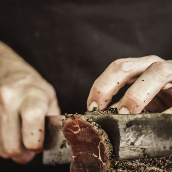 Puako Provisions & Catering - a person using a knife to cut a piece of meat - Personal Chefs Near Me - Waimea, Hawaii Puako Provisions & Catering - a person using a knife to cut a piece of meat - Personal Chefs Near Me - Waimea, Hawaii