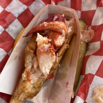 Claws - Bites taken out of a lobster roll with butter on it. To die for... - Seafood Near Me - Rockland, Maine