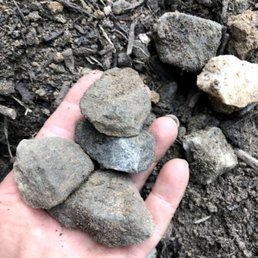 a hand holding a pile of rocks