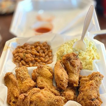 Rome’s Kitchen - a tray of fried chicken and beans - Food Trucks Near Me Rome’s Kitchen - a tray of fried chicken and beans - Food Trucks Near Me