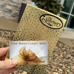 Outside the spa ambiance with the gift card we received for some lovely services
