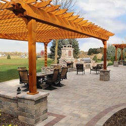 Integrity Landscape Services - Large brick paver patio with decorative seat walls, 2 pergolas, fireplace and built in grill.