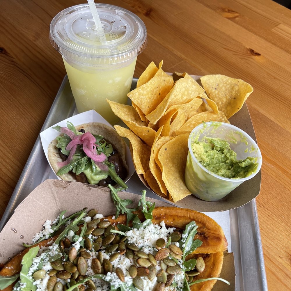 Pineapple margarita, guacamole and chips, vegan street taco and plantains.