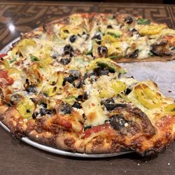 Bazbeaux Pizza - Medium, wheat crust, extra crispy Garden with eggplant, goat cheese and pepperoncini instead of green peppers, ricotta, onions.