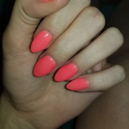 Manicured hand, pink orange neon, almond nails, dip powder nails Manicured hand, pink orange neon, almond nails, dip powder nails