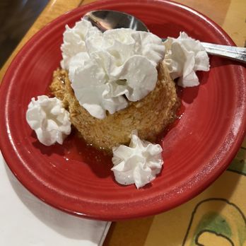 Mariscos Altamar - Flan - A dessert featuring whipped cream on top of a caramelized flan, served in a red bowl at a restaurant. - Mexican Near Me - Albuquerque, New Mexico