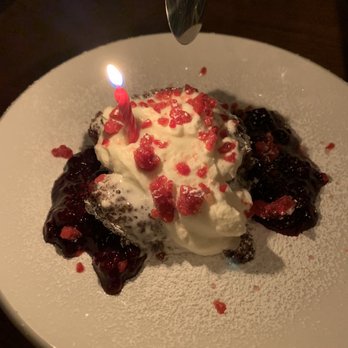 J.T. Prime - The molten cake with a much nicer name. Haha. Berry sauce over it. Delicious! - Cocktail Bars Near Me - Yuma, Arizona