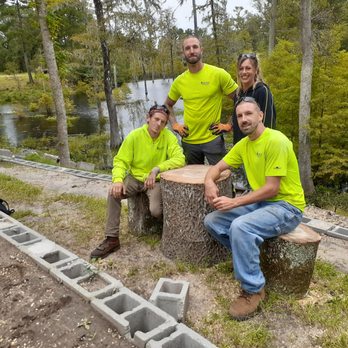 Arborvet Tree Care - The Crew with the table and stools created from the tree. - Tree Services Near Me Arborvet Tree Care - The Crew with the table and stools created from the tree. - Tree Services Near Me