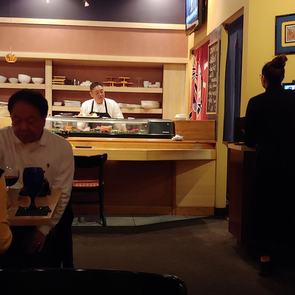 Zushi Bistro - Chef Kevin Chang making fresh sushi and greeting each customer that arrives and departs. - Sushi Bars Near Me - Virginia Beach, Virginia Zushi Bistro - Chef Kevin Chang making fresh sushi and greeting each customer that arrives and departs. - Sushi Bars Near Me - Virginia Beach, Virginia
