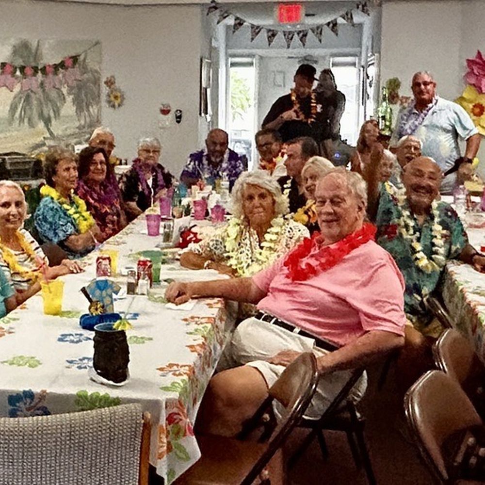 La Cosa Cibo - Happy luau attendees with Chef Scot in the back middle standing up. - Caterers Near Me La Cosa Cibo - Happy luau attendees with Chef Scot in the back middle standing up. - Caterers Near Me