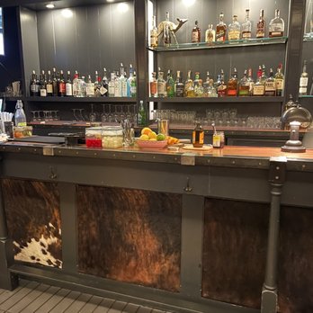 Due West Tavern - Brindle cow hide on the bar front - Cocktail Bars Near Me - Olema, California