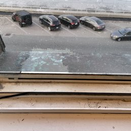 View from the room. Broken screens and filthy windows. View from the room. Broken screens and filthy windows.